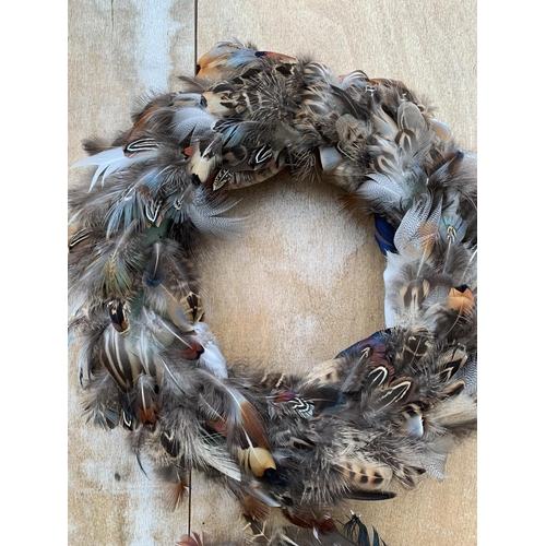 134 - TWO MEDIUM/LARGE FEATHER WREATHS 30CM IN DIAMETER + VAT TO BE SOLD FOR THE PAIR