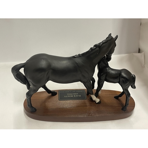 775 - A BESWICK BLACK BEAUTY AND FOAL ON A BASE