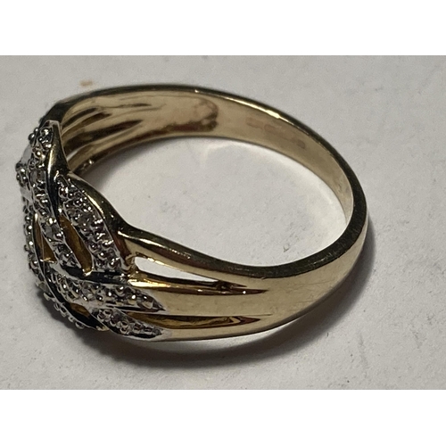 511 - A 9 CARAT GOLD RING WITH DIAMONDS IN A CROSSOVER DESIGN SIZE M