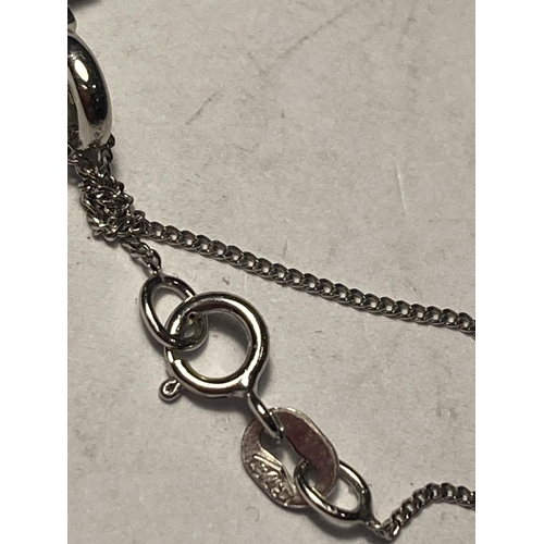 688 - A 9 CARAT WHITE GOLD CHAIN WITH A CROSS AND CLAR STONE PENDANT