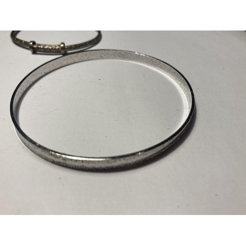 713 - THREE SILVER BANGLES