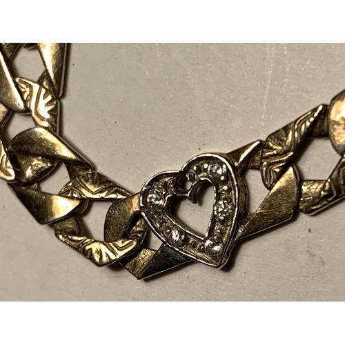 532A - A HEAVY SILVER GILT, STAMPED 925 CURB LINK BRACELET WITH MUM AND TWO HEARTS IN CLEAR STONES