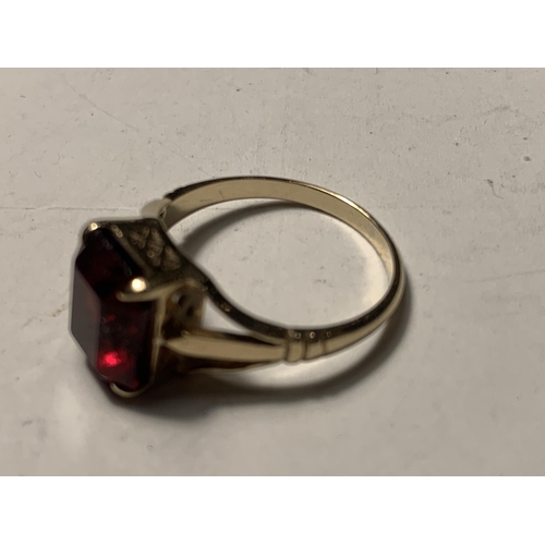 562A - A 9 CARAT GOLD RING WITH RED STONE SIZE L AND SILVER RING WITH SMALL COLOURED STONES