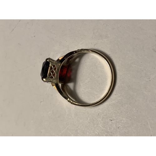 562A - A 9 CARAT GOLD RING WITH RED STONE SIZE L AND SILVER RING WITH SMALL COLOURED STONES