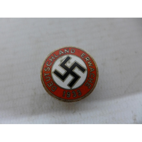 450 - A NAZI GERMANY BADGE, ENAMEL PARTY BADGE AND AN ARM BAND