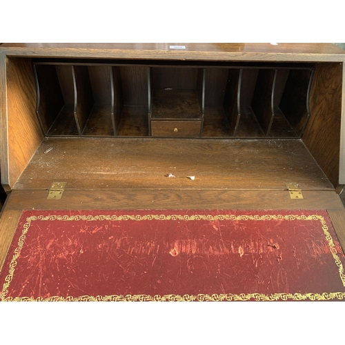 3028 - A MODERN OAK BUREAU WITH LINENFOLD DOORS TO THE BASE, 33