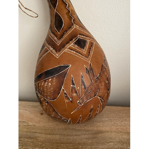 59 - A VINTAGE AFRICAN TRIBAL GOURD WITH AARDVARK AND BUTTERFLY DESIGN, HEIGHT 29.5 CM