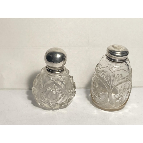 95 - TWO CUT GLASS BOTTLES WITH HALLMARKED SILVER TOPS ONE BIRMINGHAM AND ONE INDISTINCT