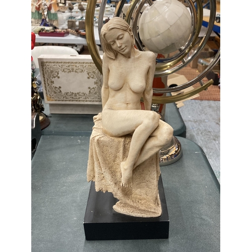 102 - A STATUE OF A NUDE WOMAN ON BLACK BASE