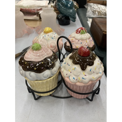 143 - FOUR POTTERY CUP CAKES AND STAND