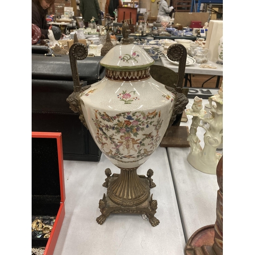 158 - A VINTAGE CERAMIC AND BRASS MOUNTED PEDESTAL URN VASE WITH PAW FEET BASE AND GIRL MASK HANDLE DESIGN