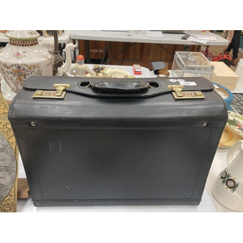 186 - A VINTAGE BLACK SUITCASE WITH CODE LOCKS