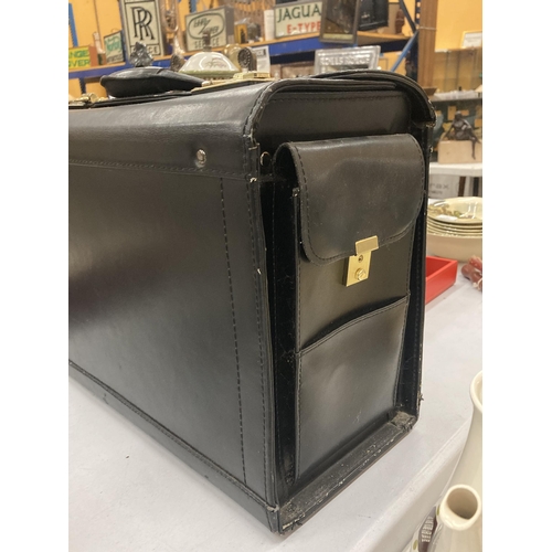 186 - A VINTAGE BLACK SUITCASE WITH CODE LOCKS