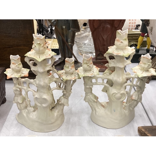 192 - A PAIR OF CONTINENTAL PORCELAIN FIGURAL CANDLESTICKS