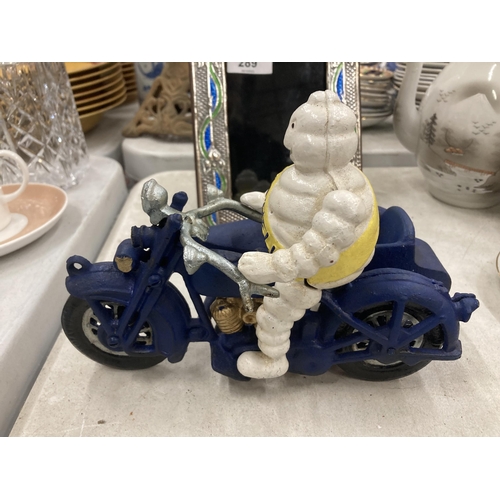 290 - A CAST METAL MICHELIN MAN ON MOTORBIKE FIGURE