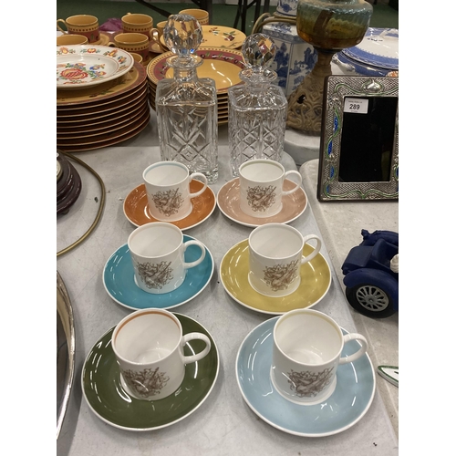 1201 - A SET OF SIX SUSIE COOPER COFFEE CUPS AND SAUCERS TOGETHER WITH TWO CUT GLASS DECANTERS