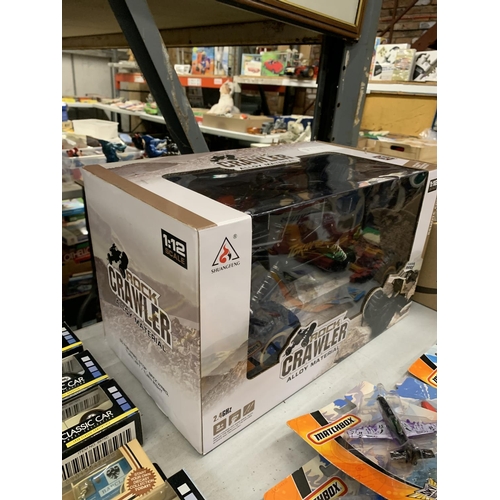 A NEW IN BOX ROCK CRAWLER REMOTE CONTROL CAR WHICH INCLUDES BATTERIES