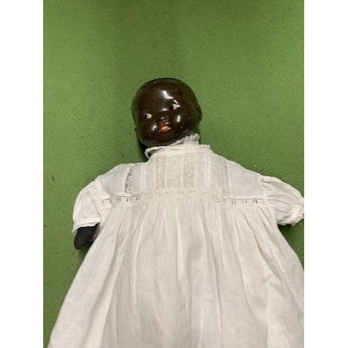 1125 - A VINTAGE DOLL WITH A CLOTH BODY, HARD PLASTIC HEAD AND ROSEBUD LIPS, MARKED TO THE BACK OF THE HEAD... 