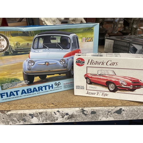 500 - FOUR CAR MODEL KITS TO INCLUDE AN AIRFIX JAGUAR 'E' TYPE, REVELL VW GOLF 1 GTI, TAMIYA FIAT ABARTH A... 