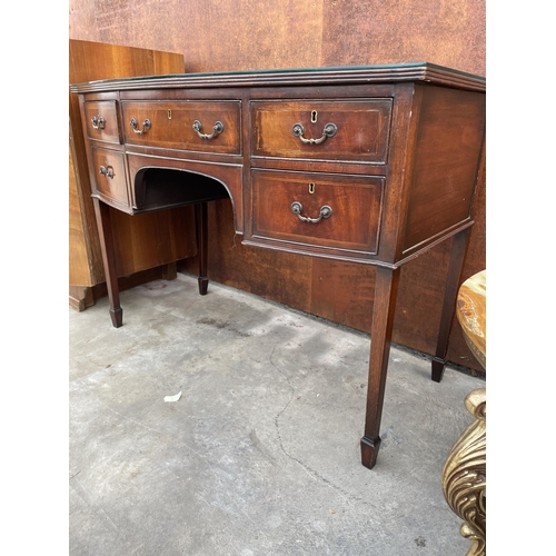 2504 - AN EDWARDIAN MAHOGANY AND INLAID KNEEHOLE DESK ENCLOSING FIVE DRAWERS AND TAPERING LEGS WITH SPADE F... 