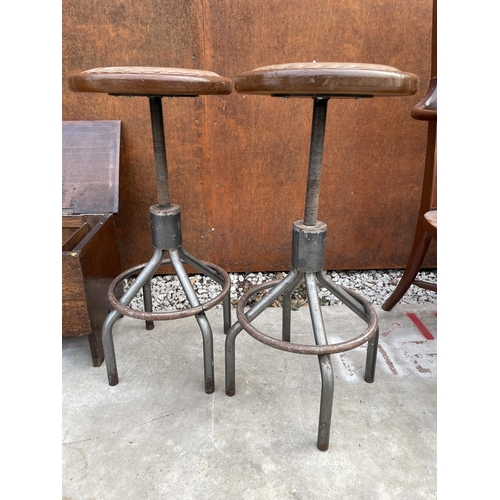 2507 - A PAIR OF INDUSTRIAL STOOLS ON TUBULAR METAL BASE