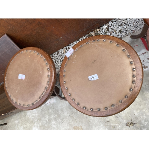 2507 - A PAIR OF INDUSTRIAL STOOLS ON TUBULAR METAL BASE