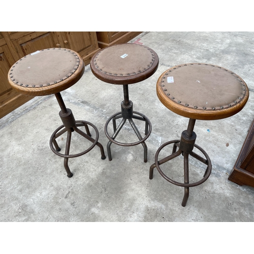 2509 - THREE INDUSTRIAL STOOLS ON TUBULAR METAL BASE