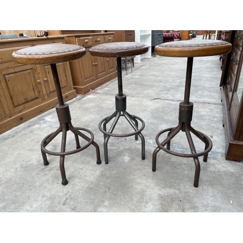 2509 - THREE INDUSTRIAL STOOLS ON TUBULAR METAL BASE