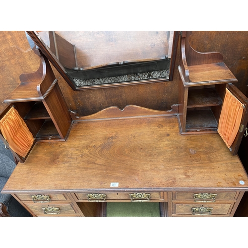 2511 - A VICTORIAN WALNUT KNEEHOLE DRESSING TABLE ENCLOSING NINE DRAWERS, TWO GLAZED CUPBOARDS AND FOOTREST... 