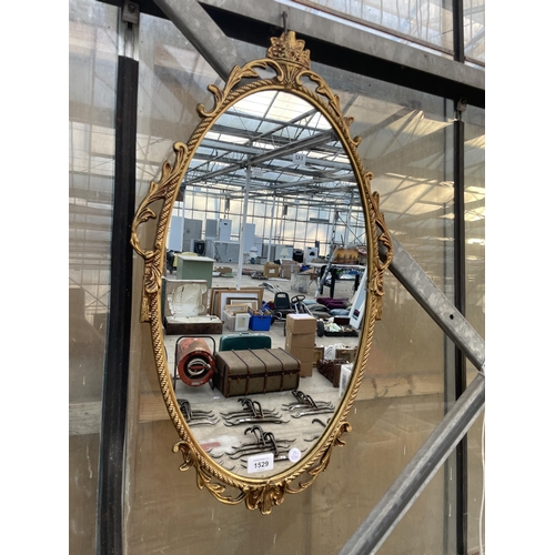 1529 - A DECORATIVE BRASS FRAMED WALL MIRROR