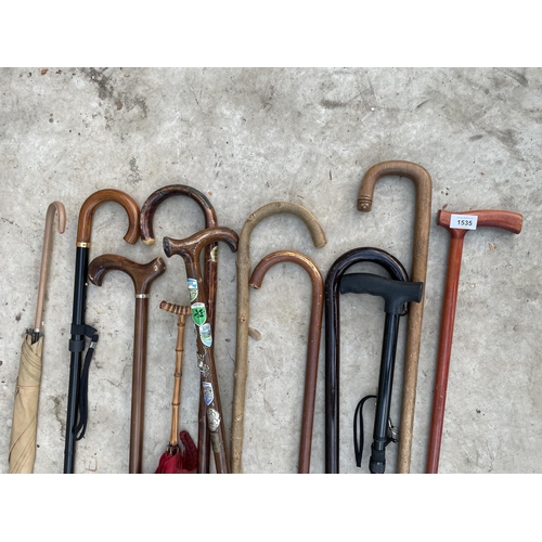 1535 - AN ASSORTMENT OF WALKING STICKS AND UMBRELLAS