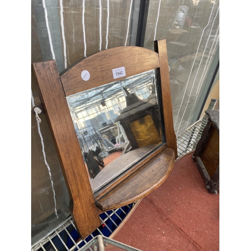 1542 - AN OAK FRAMED WALL MIRROR WITH LOWER SHELF