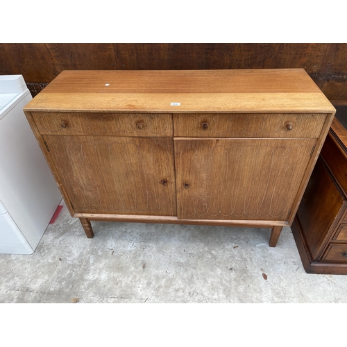 2516 - A GORDON RUSSELL ELLIPSES RETRO TEAK SIDEBOARD ENCLOSING TWO DRAWERS AND TWO CUPBOARDS WITH CIRCULAR... 