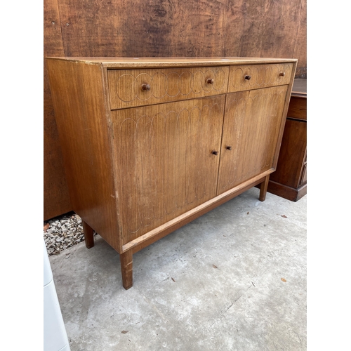 2516 - A GORDON RUSSELL ELLIPSES RETRO TEAK SIDEBOARD ENCLOSING TWO DRAWERS AND TWO CUPBOARDS WITH CIRCULAR... 