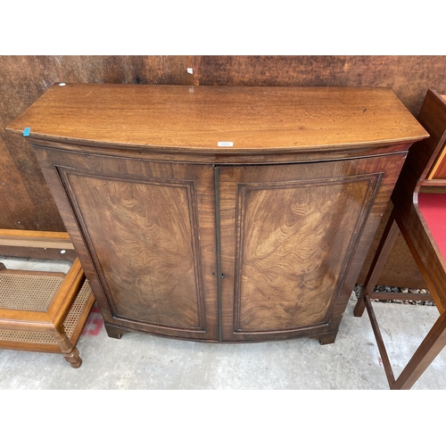 2532 - A 19TH CENTURY MAHOGANY BOWFRONTED TWO DOOR CUPBOARD ON BRACKET FEET, 45.5