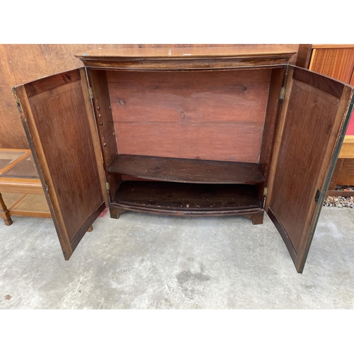 2532 - A 19TH CENTURY MAHOGANY BOWFRONTED TWO DOOR CUPBOARD ON BRACKET FEET, 45.5