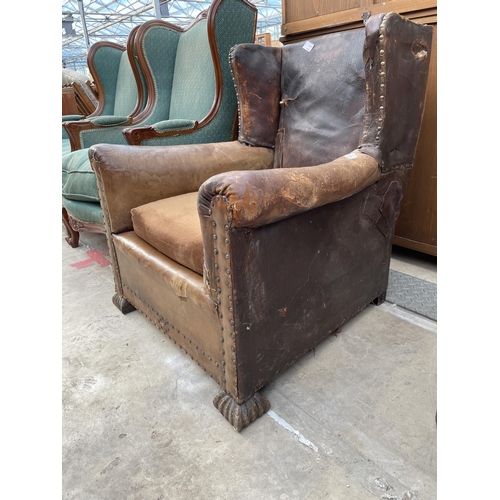 2534 - AN EARLY 20TH CENTURY LEATHER STUDDED WINGED FIRESIDE CHAIR AND SIMILAR CHAIR