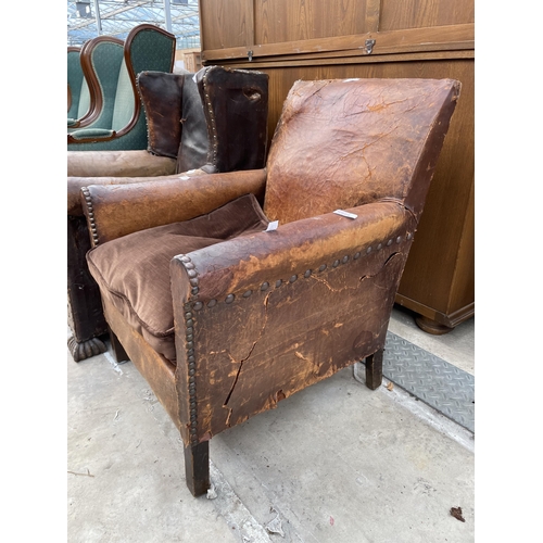 2534 - AN EARLY 20TH CENTURY LEATHER STUDDED WINGED FIRESIDE CHAIR AND SIMILAR CHAIR