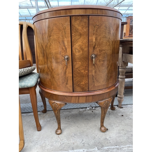 2540 - A MID 20TH CENTURY WALNUT BOWFRONTED TWO DOOR CABINET ON CABRIOLE LEGS, 31