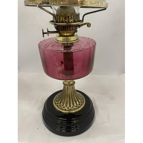 26 - A VINTAGE OIL LAMP WITH WHITE GLASS SHADE, GLASS FUNNEL, CRANBERRY COLOURED GLASS OIL RESERVOIR