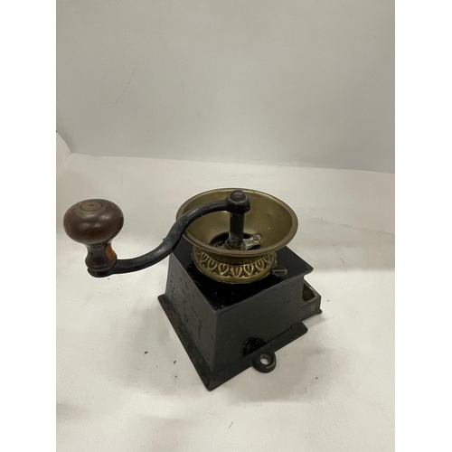 33 - AN A.KENDRICK & SONS PATENT COFFEE MILL WITH A BRASS BOWL STYLE TOP AND A TURNING HANDLE. THERE IS A... 