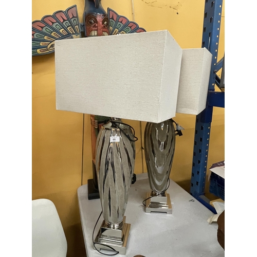 68 - A PAIR OF DESIGNER MODERN FLOOR LAMPS ON CHROME EFFECT BASES WITH SHADES
