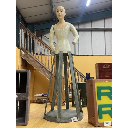 76 - AN UNUSUAL PAINTED WOODEN DOLL ON STAND WITH MOVEABLE ARMS