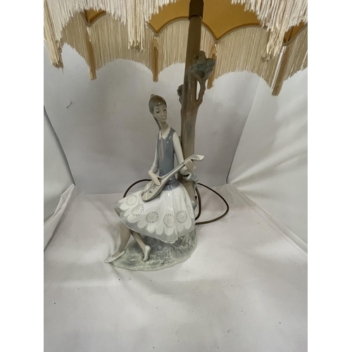 87 - A LLADRO LAMP - THE FIGURE OF A GIRL PLAYING A MANDOLIN WITH A CREAM SHADE