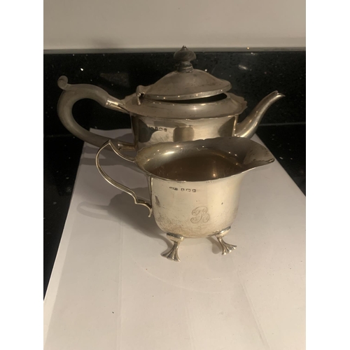 60 - TWO HALLMARKED BIRMINGHAM SILVER ITEMS TO INCLUDE A TEAPOT AND A JUG ON FEET WEIGHT 345 GRAMS