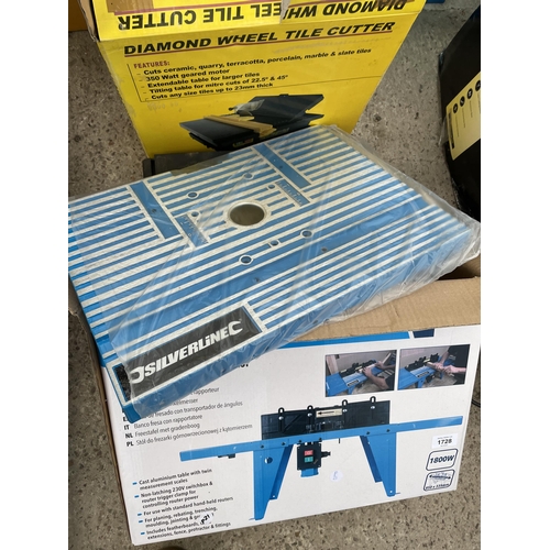 A BOXED SILVERLINE ROUTER TABLE AND A TILE CUTTER