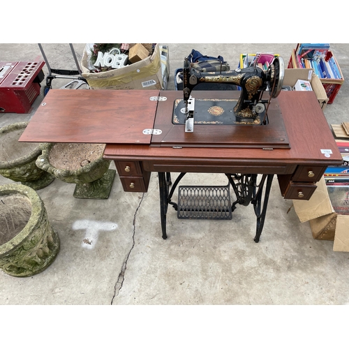 1784 - A VINTAGE JONES SEWING MACHINE WITH TREADLE BASE AND DRAWERS ETC