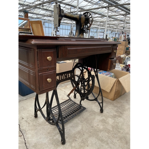 1784 - A VINTAGE JONES SEWING MACHINE WITH TREADLE BASE AND DRAWERS ETC