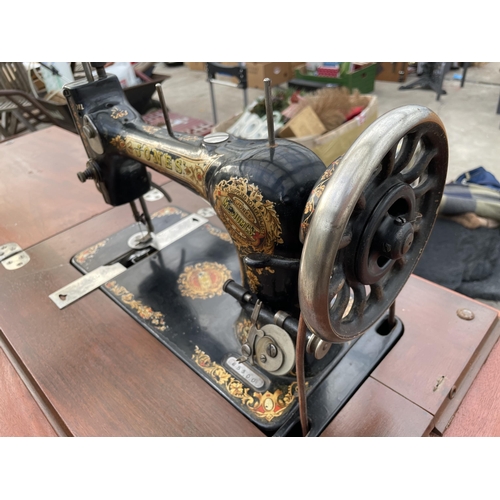 1784 - A VINTAGE JONES SEWING MACHINE WITH TREADLE BASE AND DRAWERS ETC