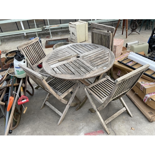 1804 - A TEAK GARDEN FURNITURE SET COMPRISING OF A ROUND TABLE AND FOUR CHAIRS